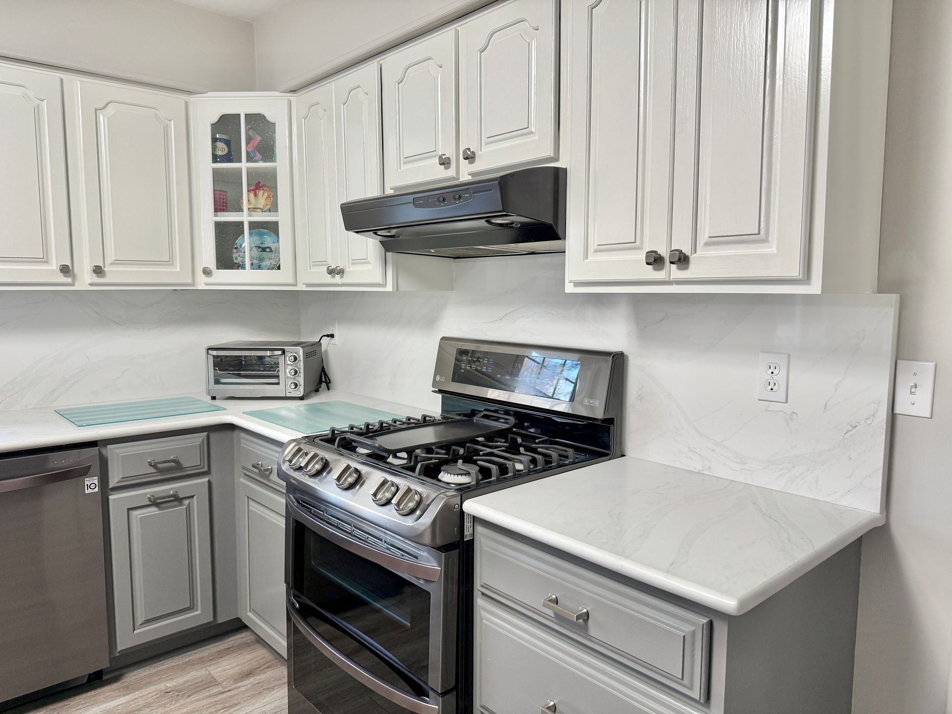 High-end transformation focusing on cabinetry, stone, and backsplash.