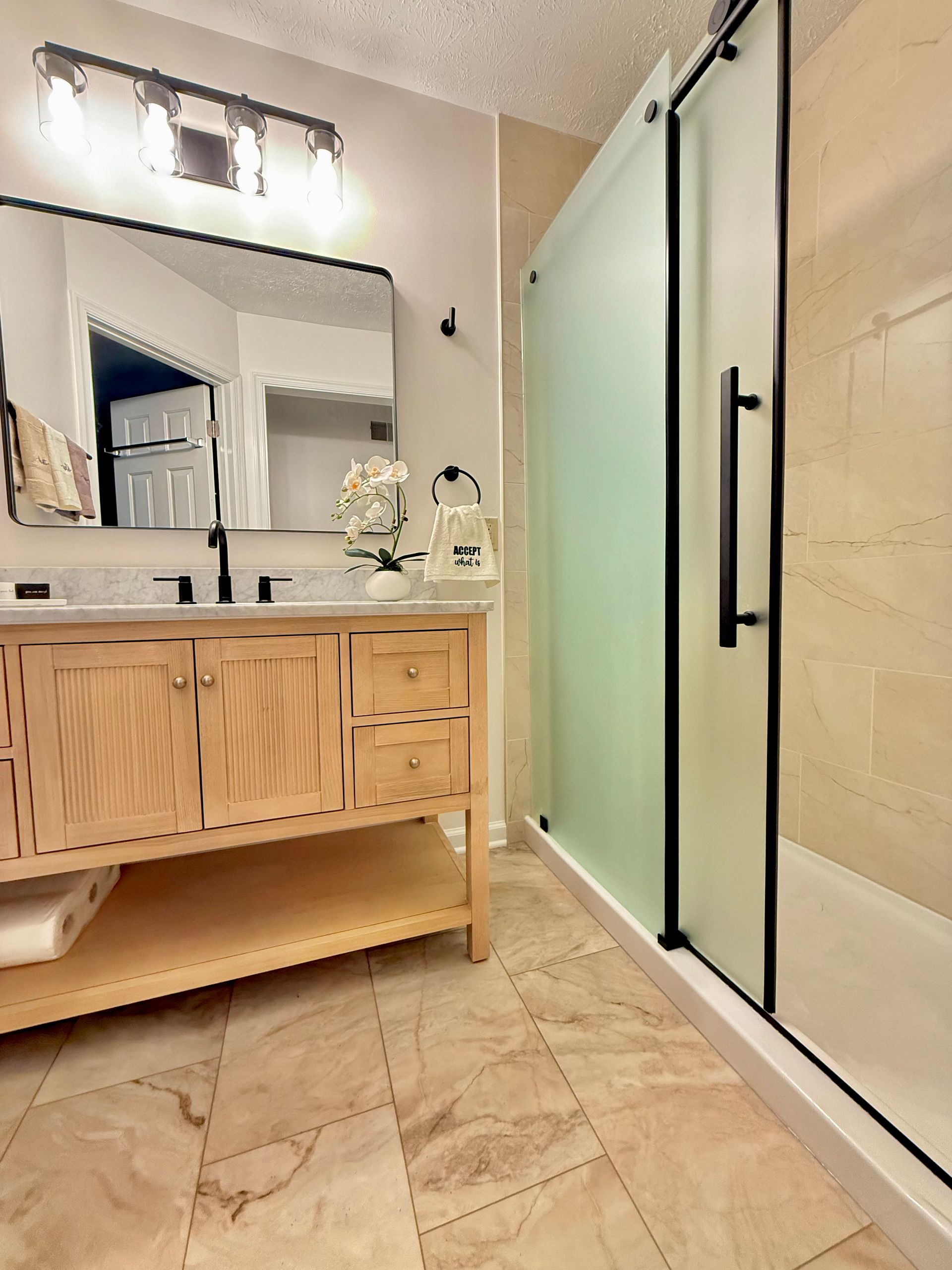 Professional installation of matte black shower trim and fixtures in Owings Mills bathroom.