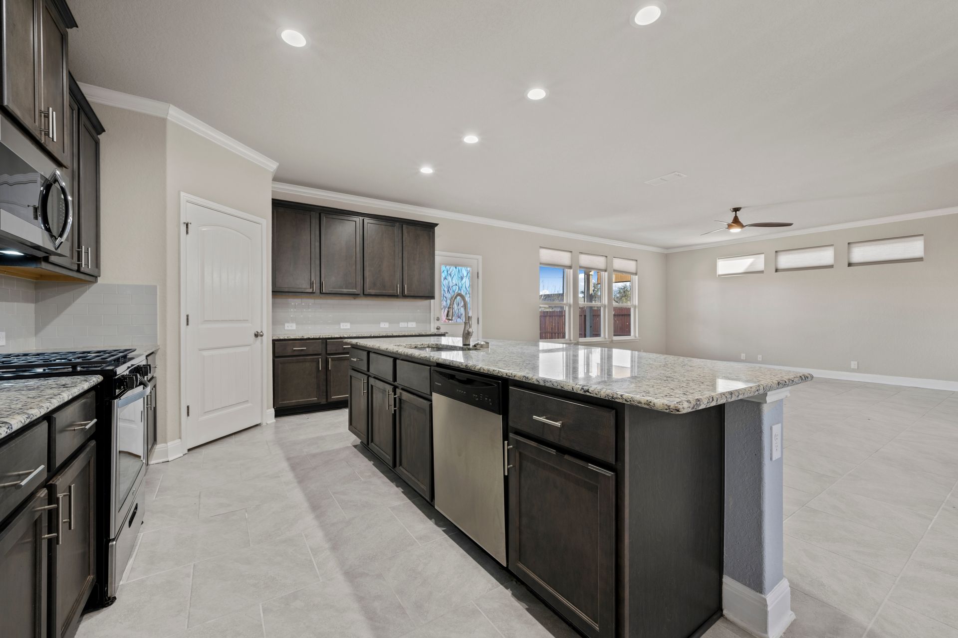 Elegant dark cabinet kitchen in Columbia, Maryland, showcasing a traditional design with modern touches, granite counters, and a large island.