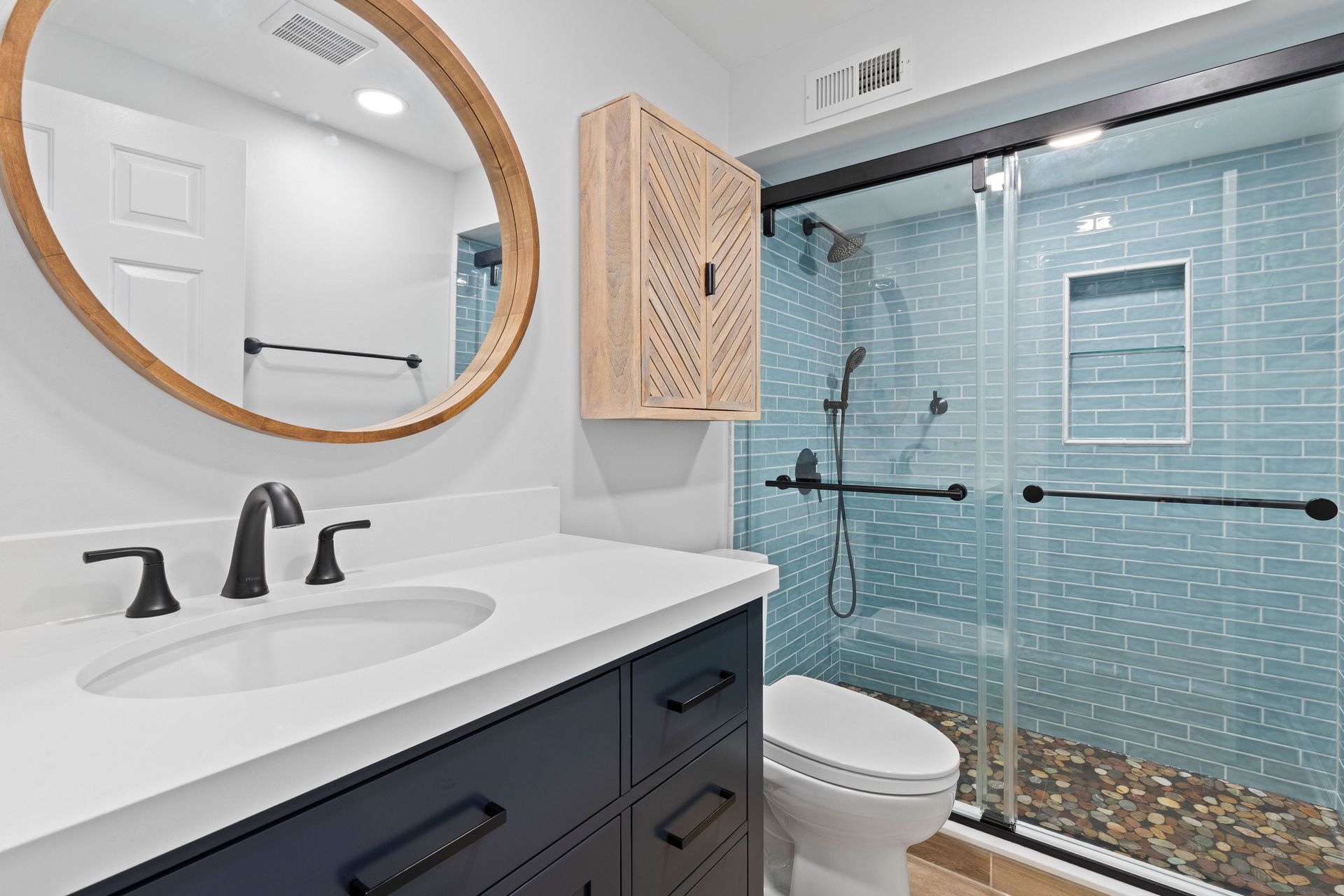 A detailed shot of the custom floating vanity's wood grain and the new black drawer pulls.
