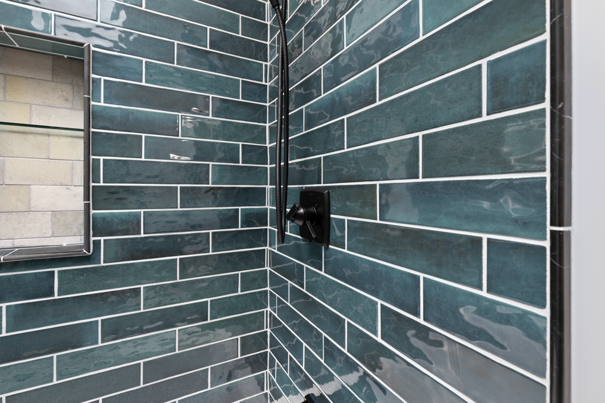Custom tile installation for showers in Ellicott City, MD, including decorative niches and meticulous grout lines.