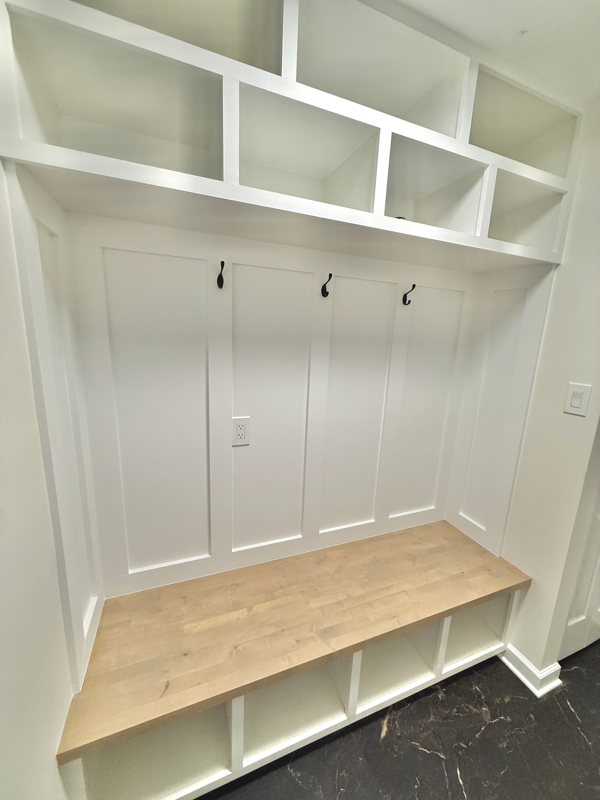 Monkton Custom Mudroom: board-and-batten paneling with built-in bench and overhead storage cubbies.