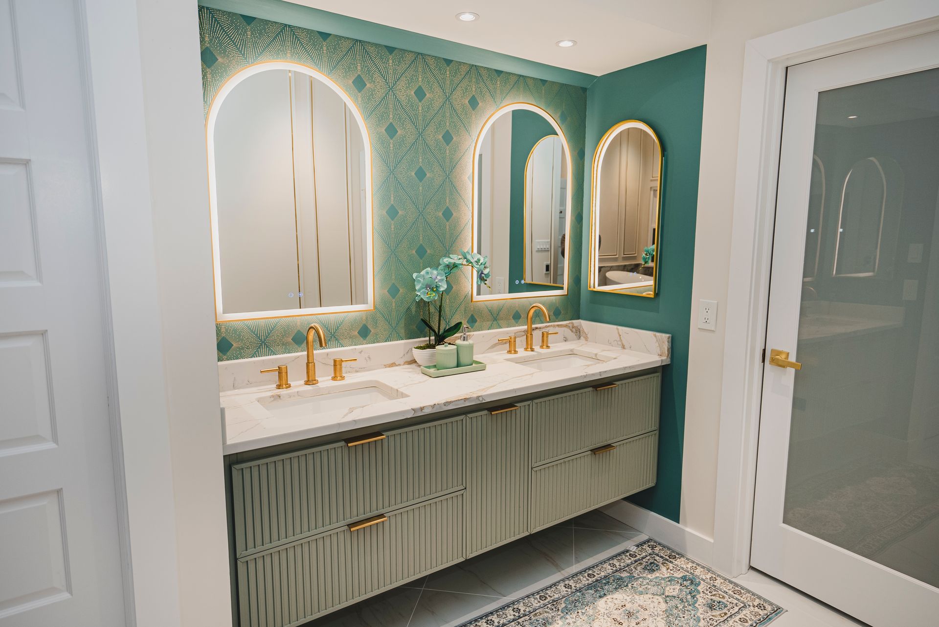 Sage green fluted bathroom vanity with white quartz countertop.