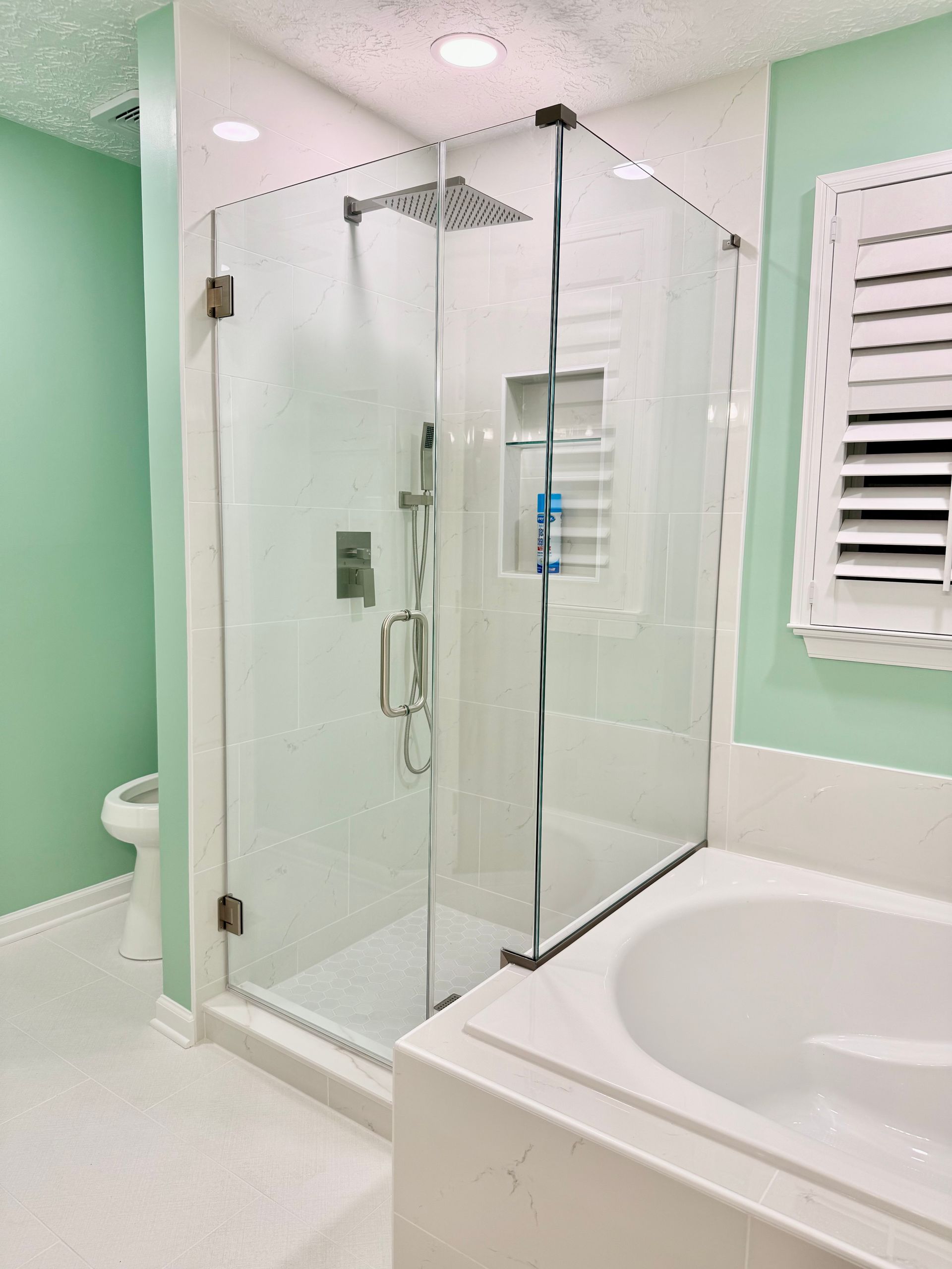 Detail of the precise tile work and clean fixture installation on the renovated soaking tub deck.