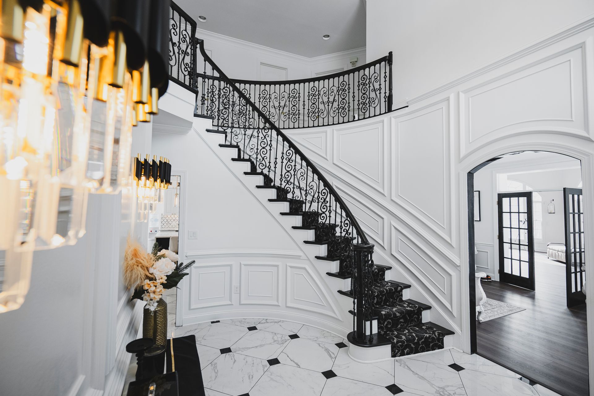 Staircase upgrade featuring custom wrought iron balusters with ornate metal scrollwork.