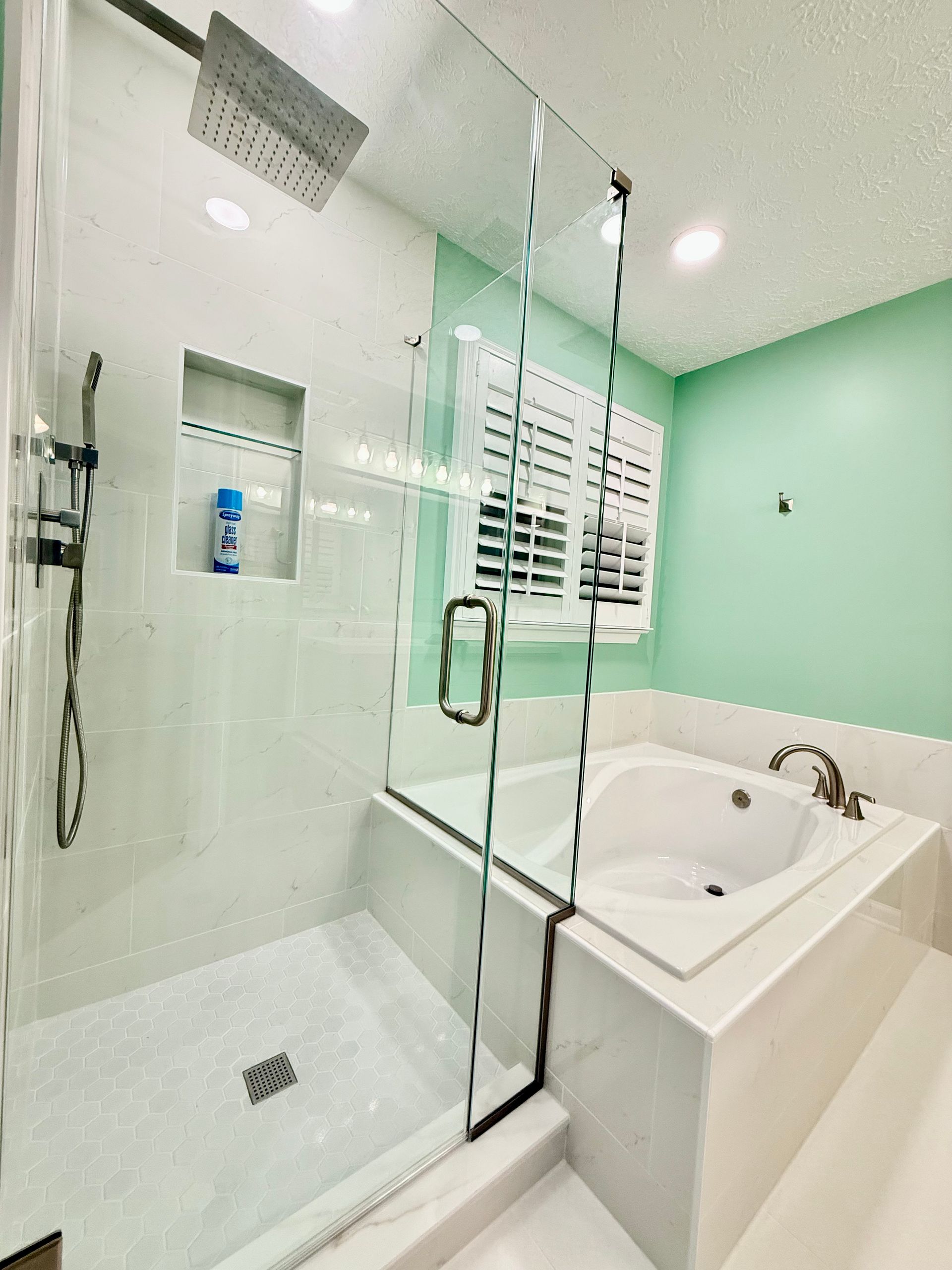 Full view of our successful master bath renovation, blending custom vanity and soaking tub installation.