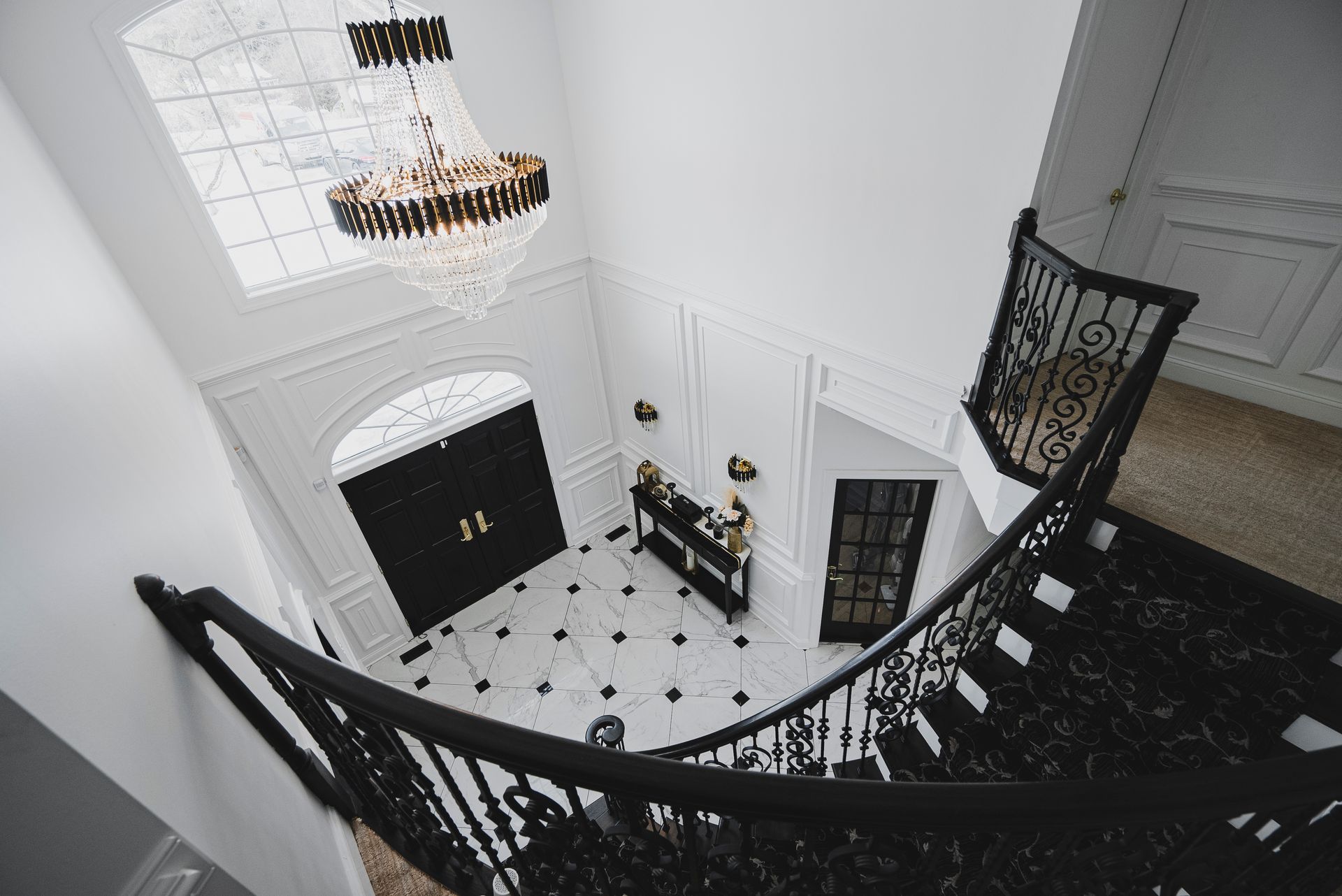 Modern classical foyer design inspiration with custom trim and luxury lighting.