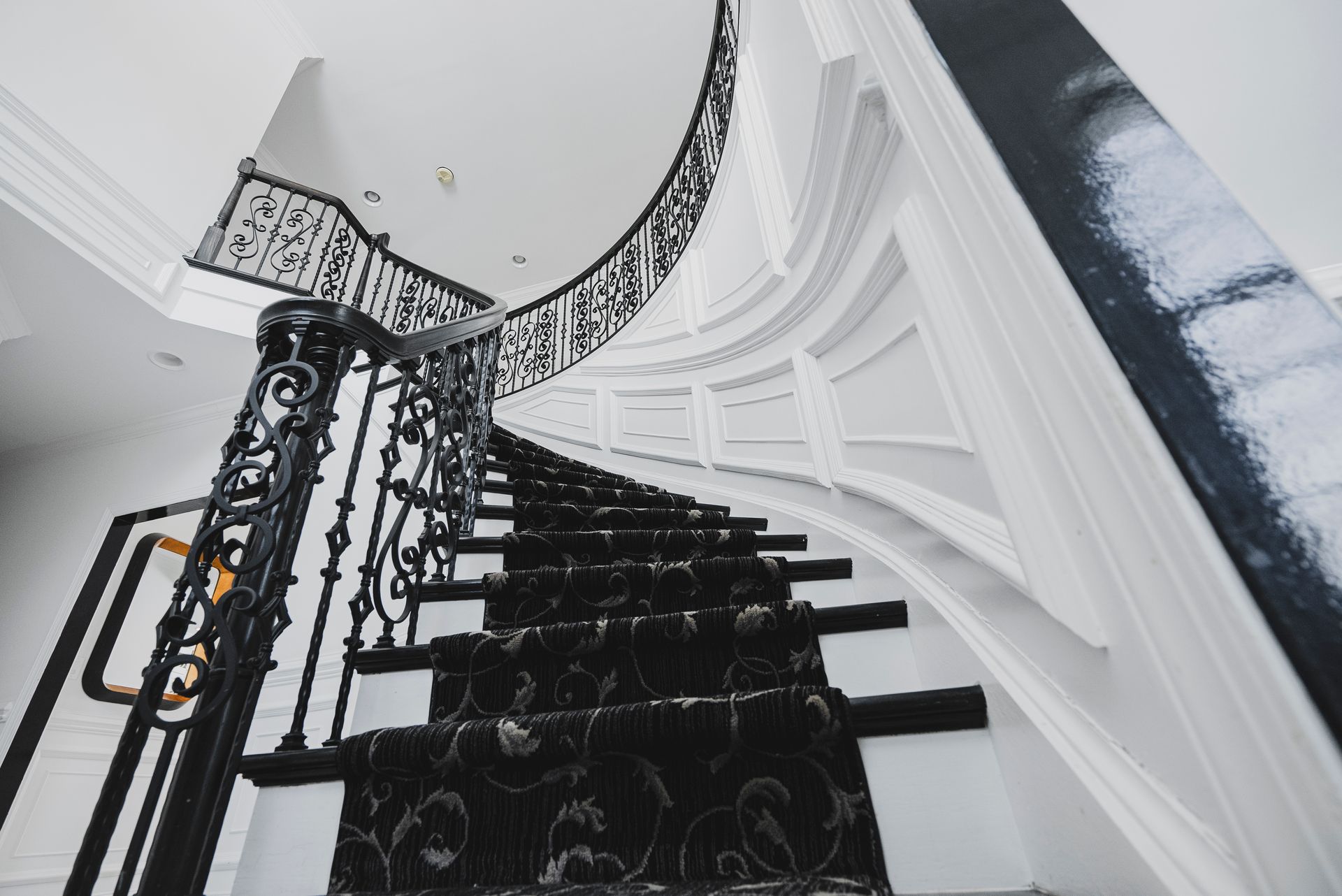 Refinished oak stair treads with a dark espresso stain and crisp white risers.