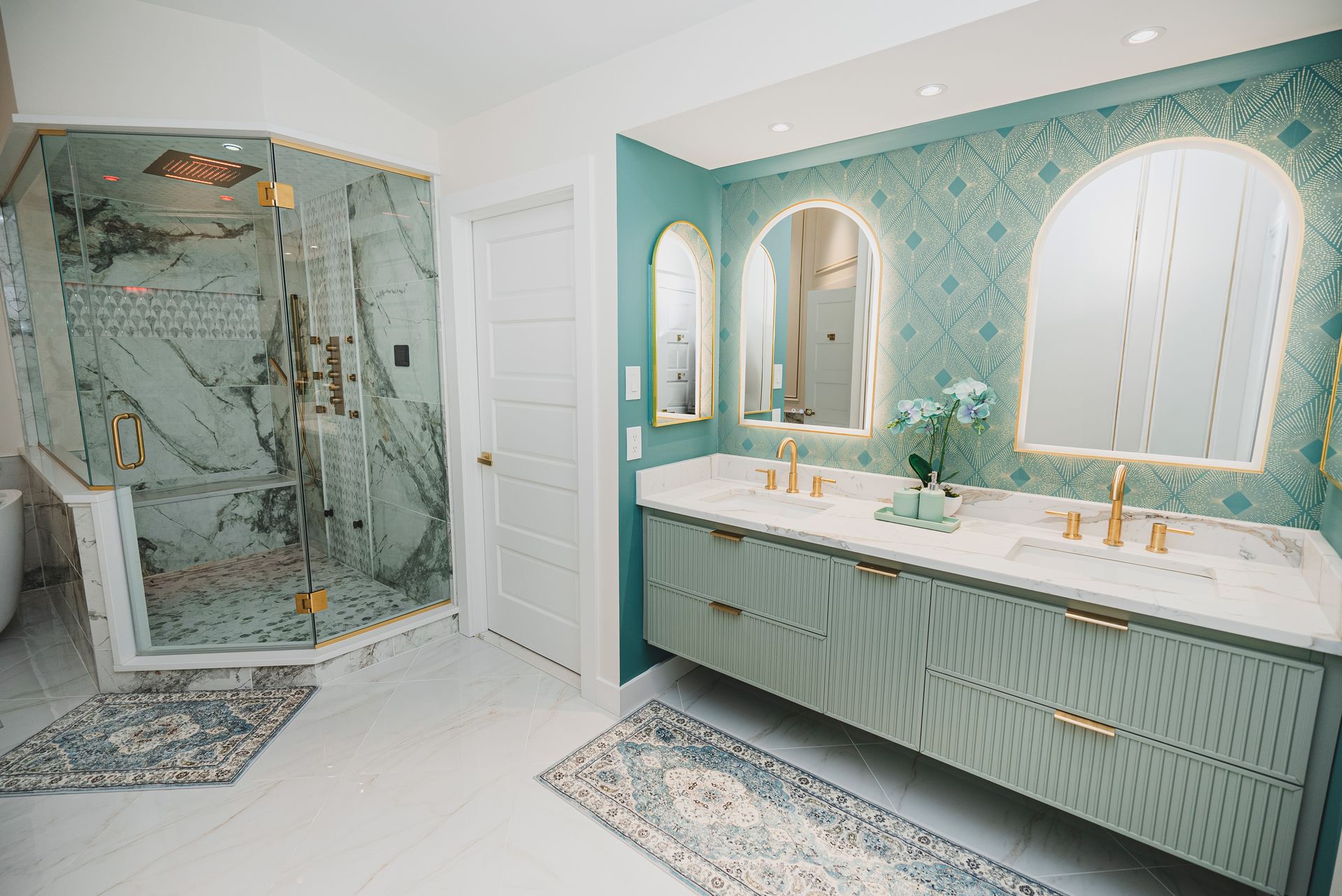 Custom pebble stone shower floor installation with seamless glass door.
