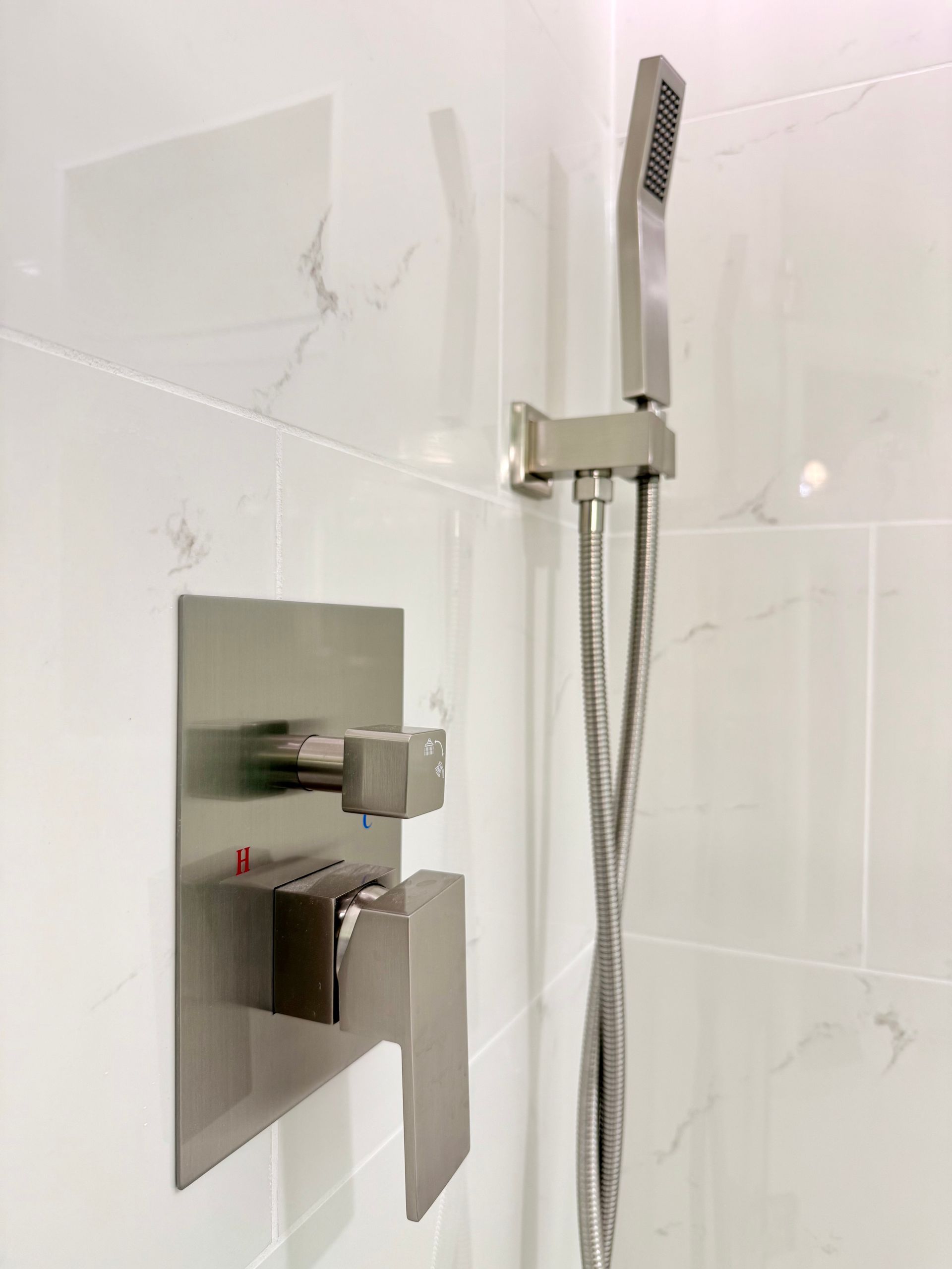 Quality craftsmanship shown in the fully tiled soaking tub surround and glass shower enclosure in this bathroom remodel.