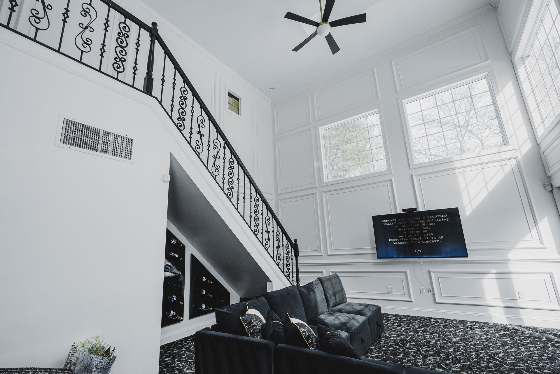 Full-wall fireplace installation by A-1 Renovations showcasing integrated quartz and decorative wood columns.