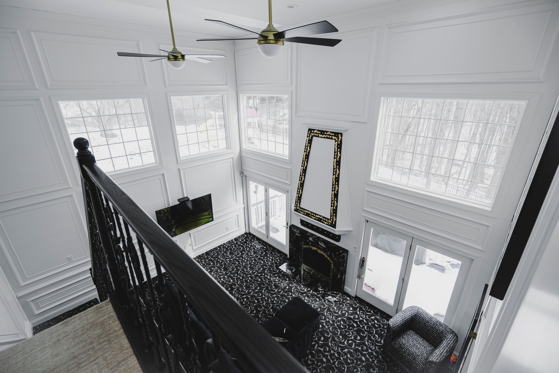 A custom-designed living room focal point featuring a white artisan mantel and modern quartz stone facing.