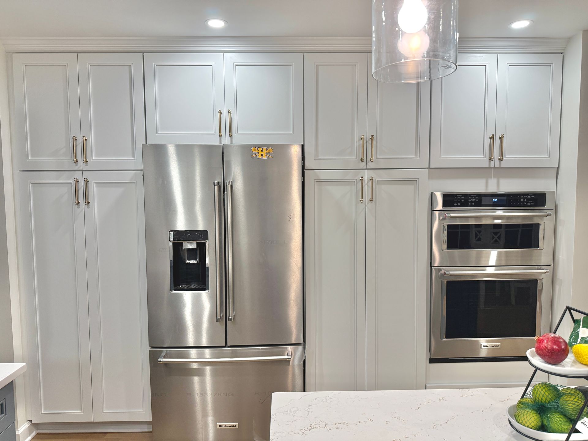 Precision installation of kitchen hood and surrounding cabinetry, ensuring perfect alignment.