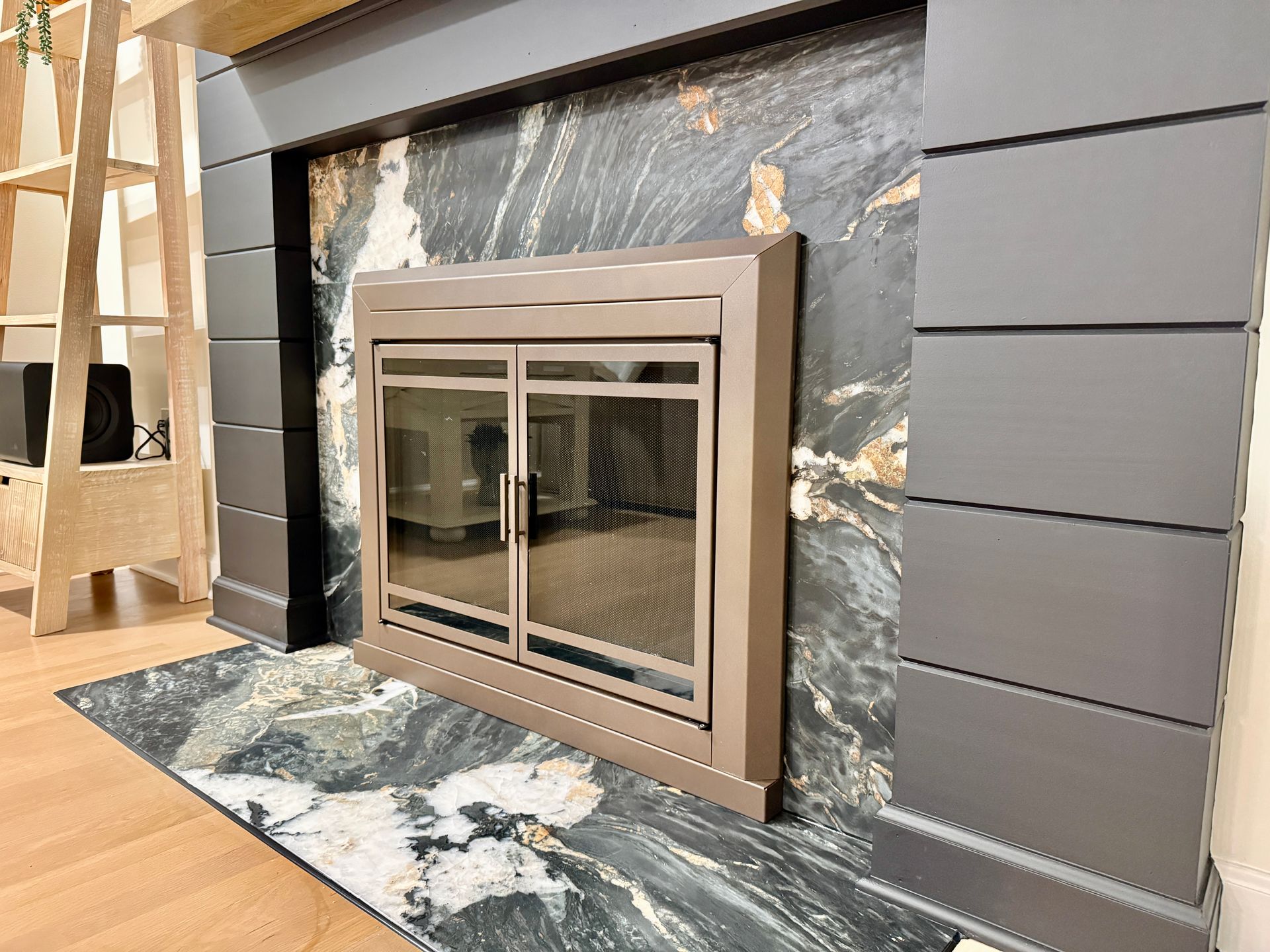Detail of the custom-cut natural stone hearth and precision alignment with the wood floating mantel.