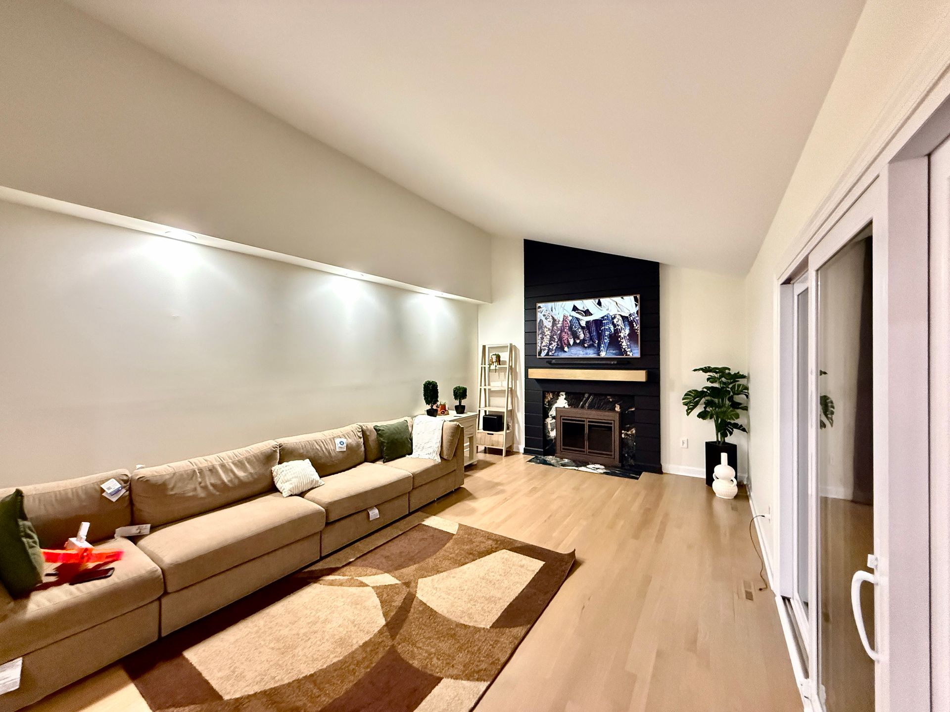 High-end media wall installation showing seamless integration with modern living room design and concealed wiring.
