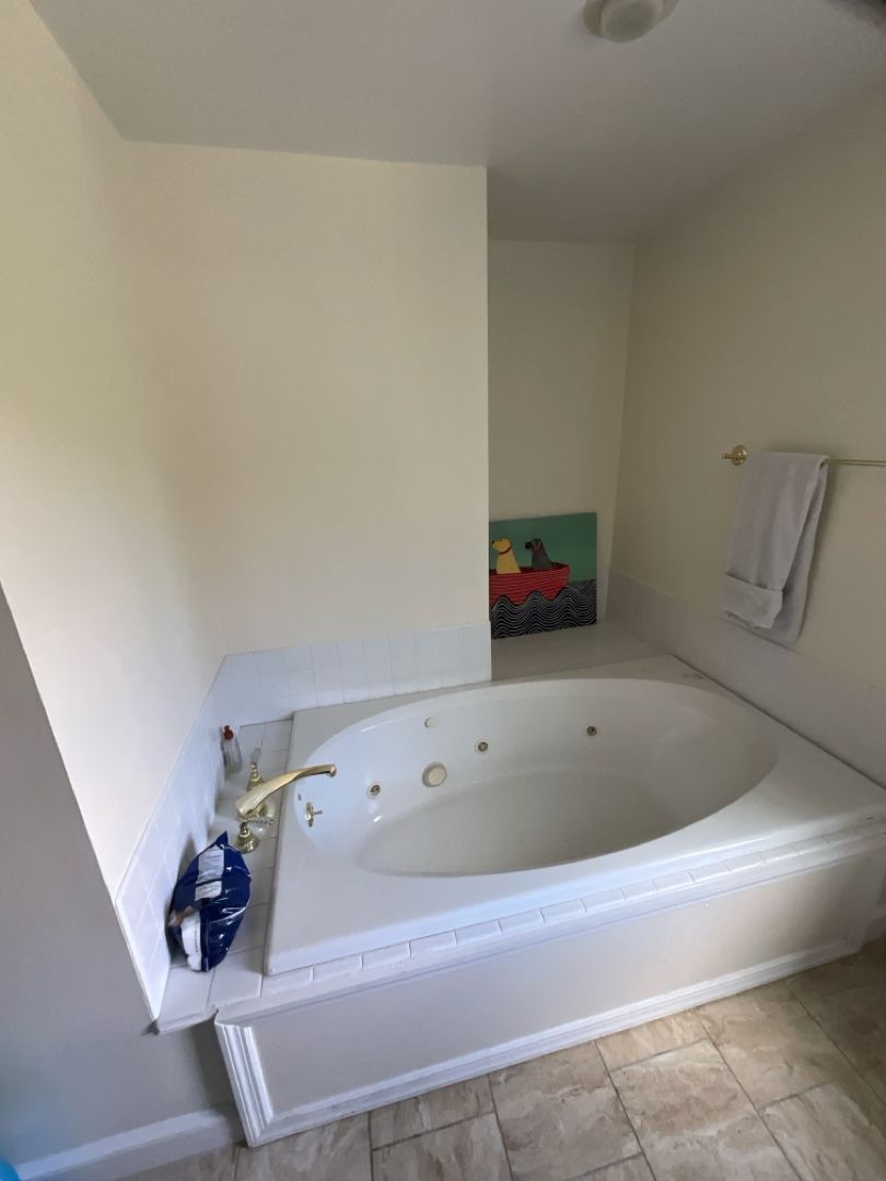 Outdated, space-consuming built-in jetted tub before a bathroom renovation