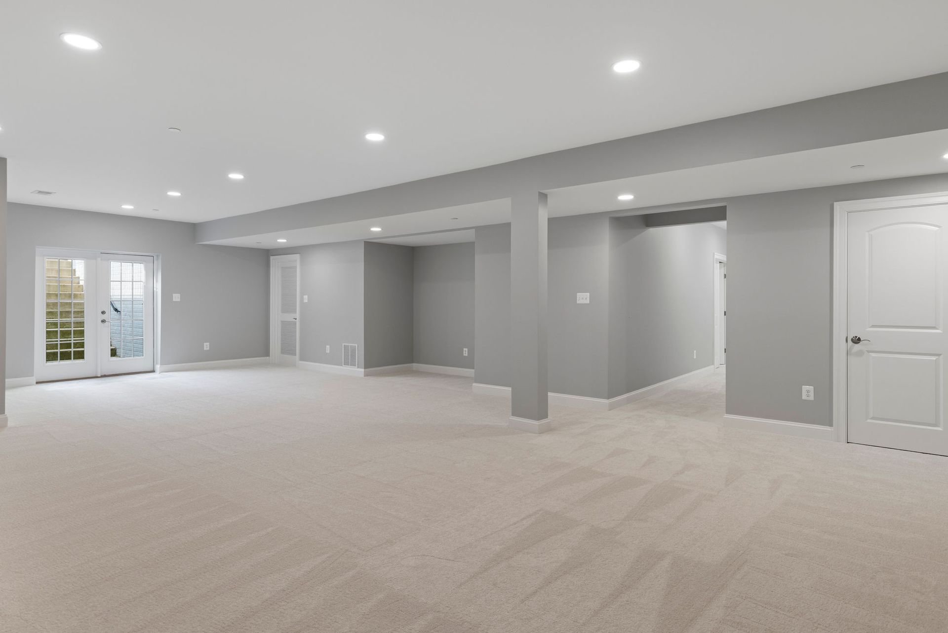 A finished basement with a home gym, cinema room, and a full bathroom, after a complete renovation.