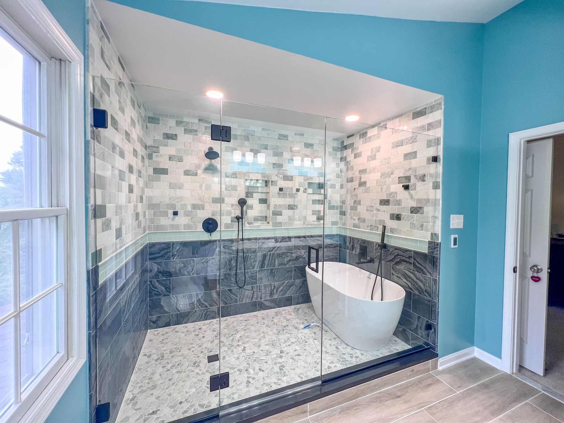Bathroom renovation in Ellicott City, MD, highlighting the open layout, natural light, and modern aesthetic.
