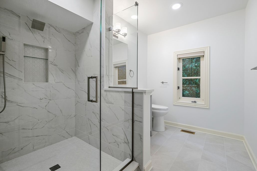 New bathroom fixtures on a white counter and a glass shower door.