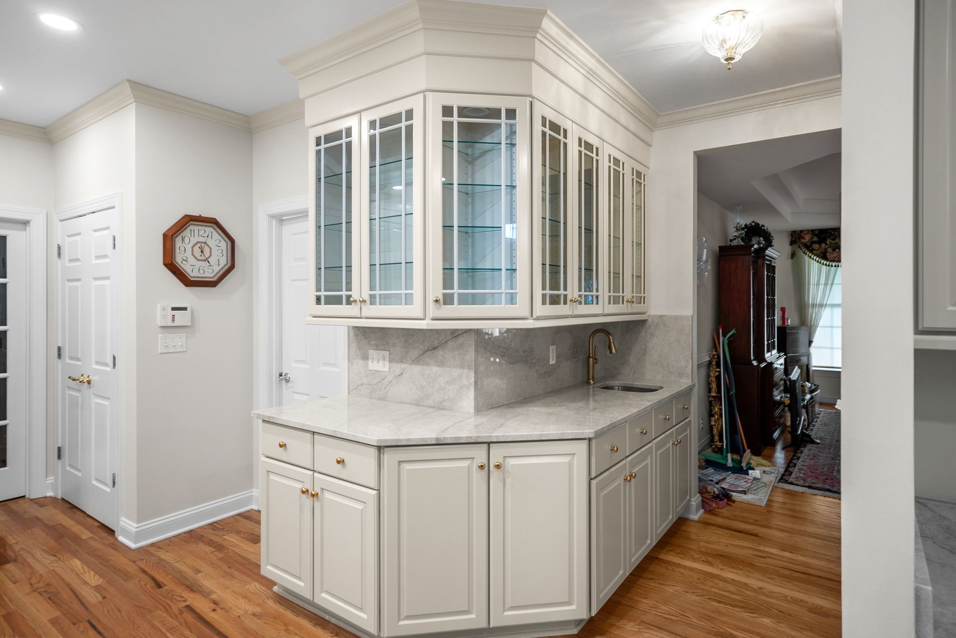 Custom full-height stone slab backsplash and matching quartz countertop with undermount sink