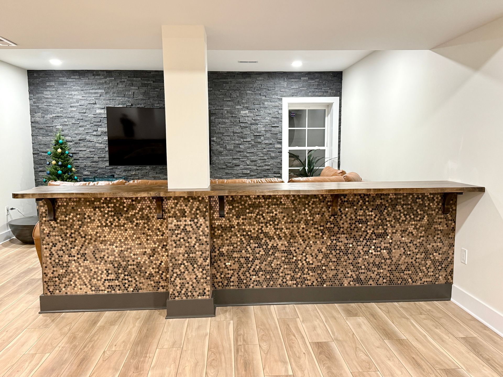 Basement sitting bar with integrated electrical outlets and wood top.