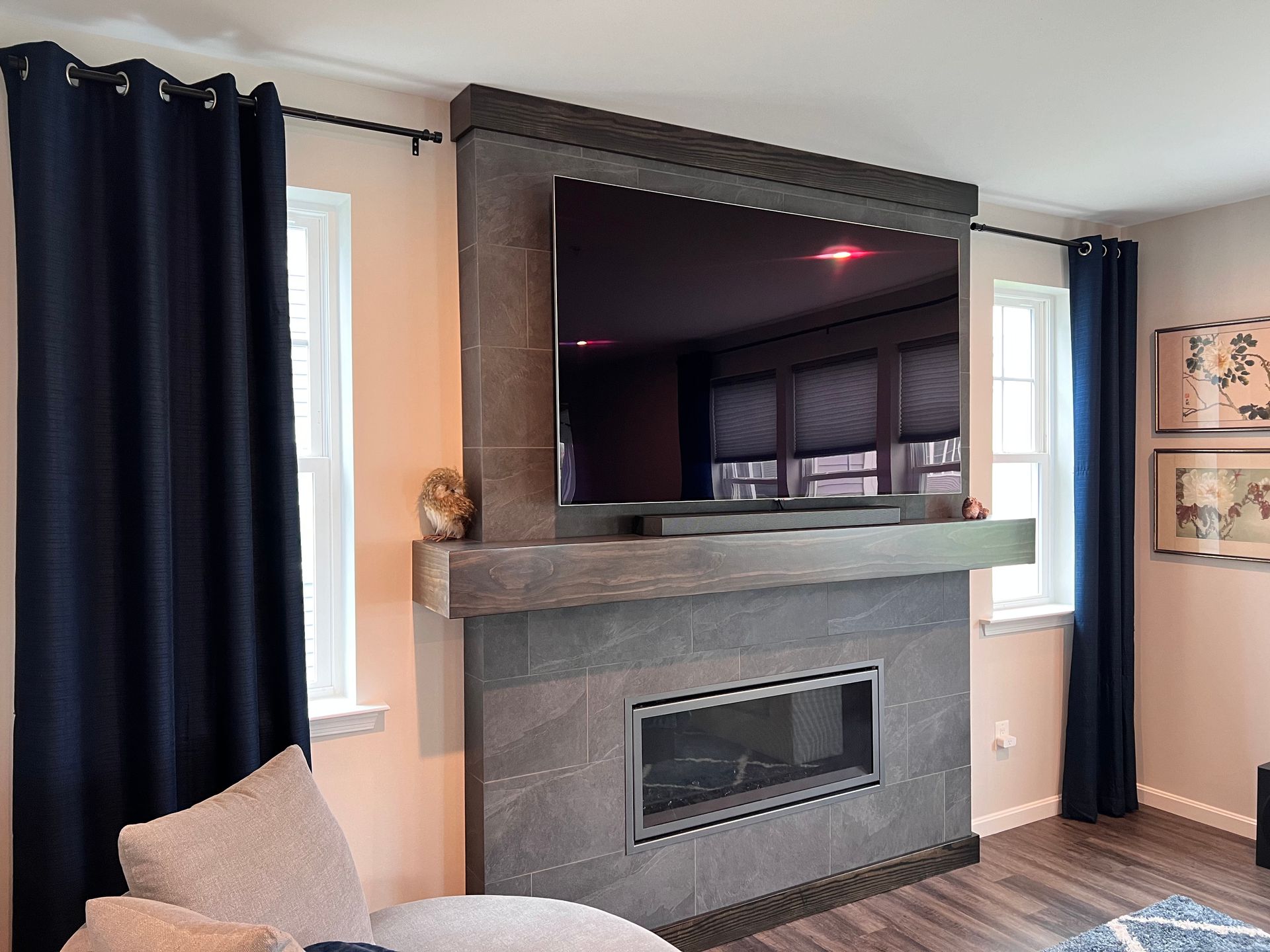 Custom fireplace surround with a mantel and integrated TV in Fallston 
 home.