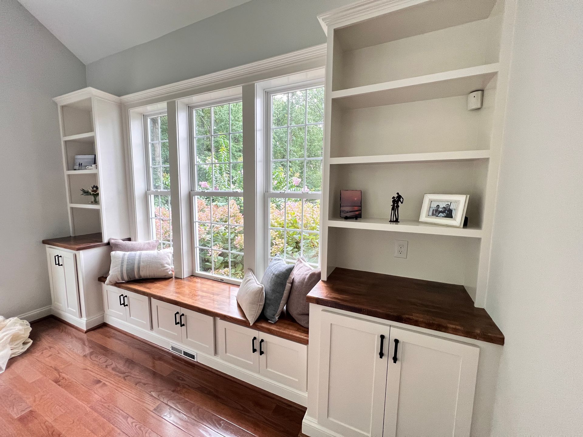 Custom built-in bookshelves surrounding a window in Fallston home.