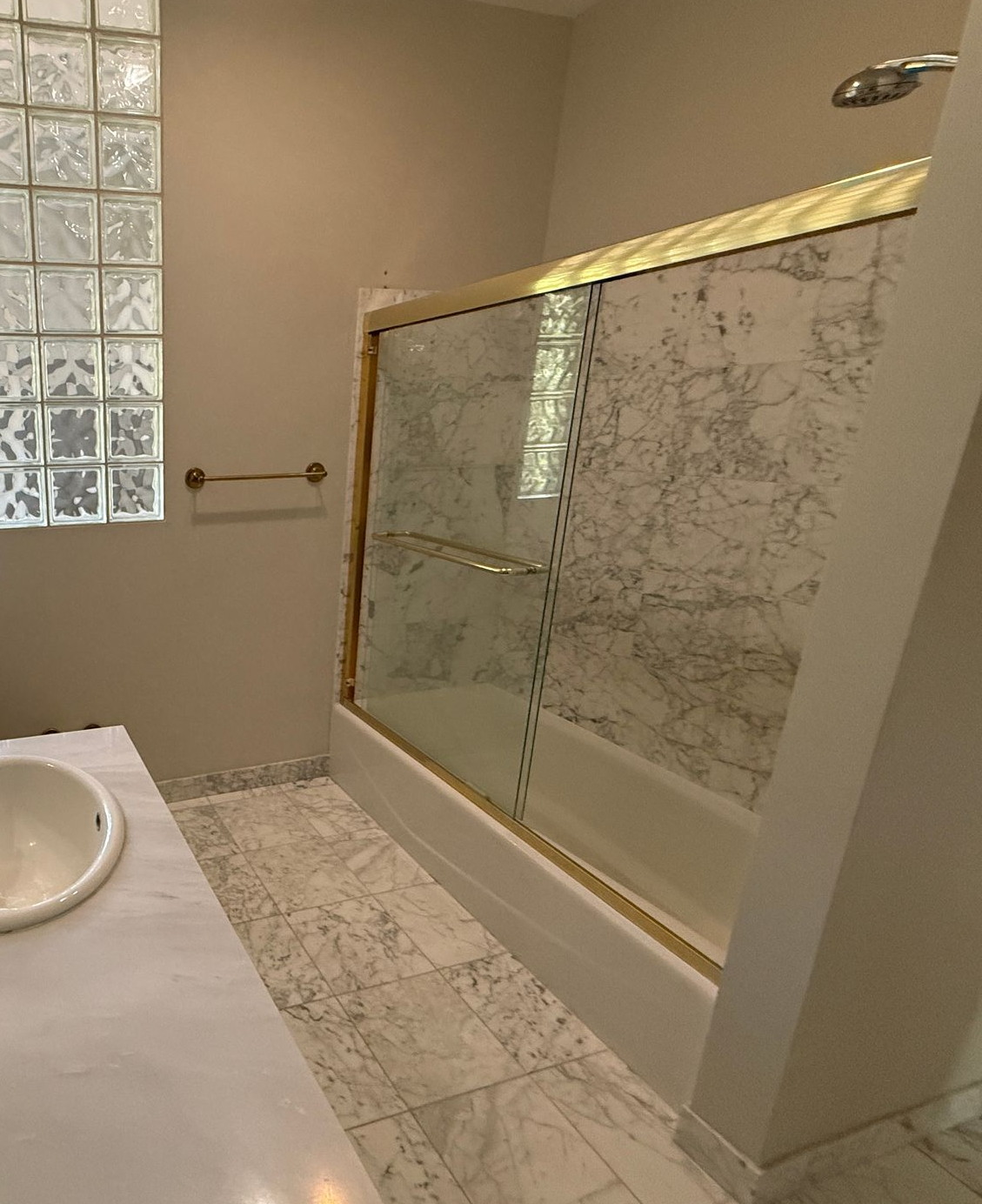 An outdated bathroom with brass fixtures and a mirrored wall, showing a perfect space for a modern bathroom remodel in Cockeysville, MD.