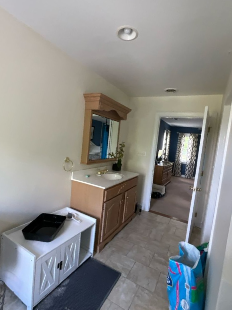 Before photo of a dated master bathroom needing a modern remodel in Maryland