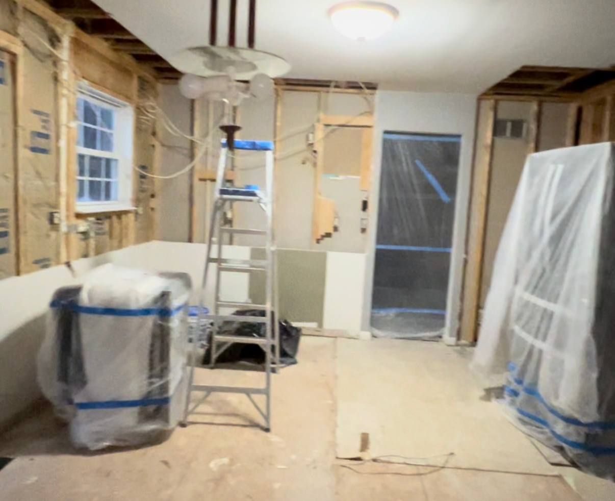 Modern kitchen remodeling in Sykesville, MD, with light gray cabinets, a spacious island, and stainless steel appliances.