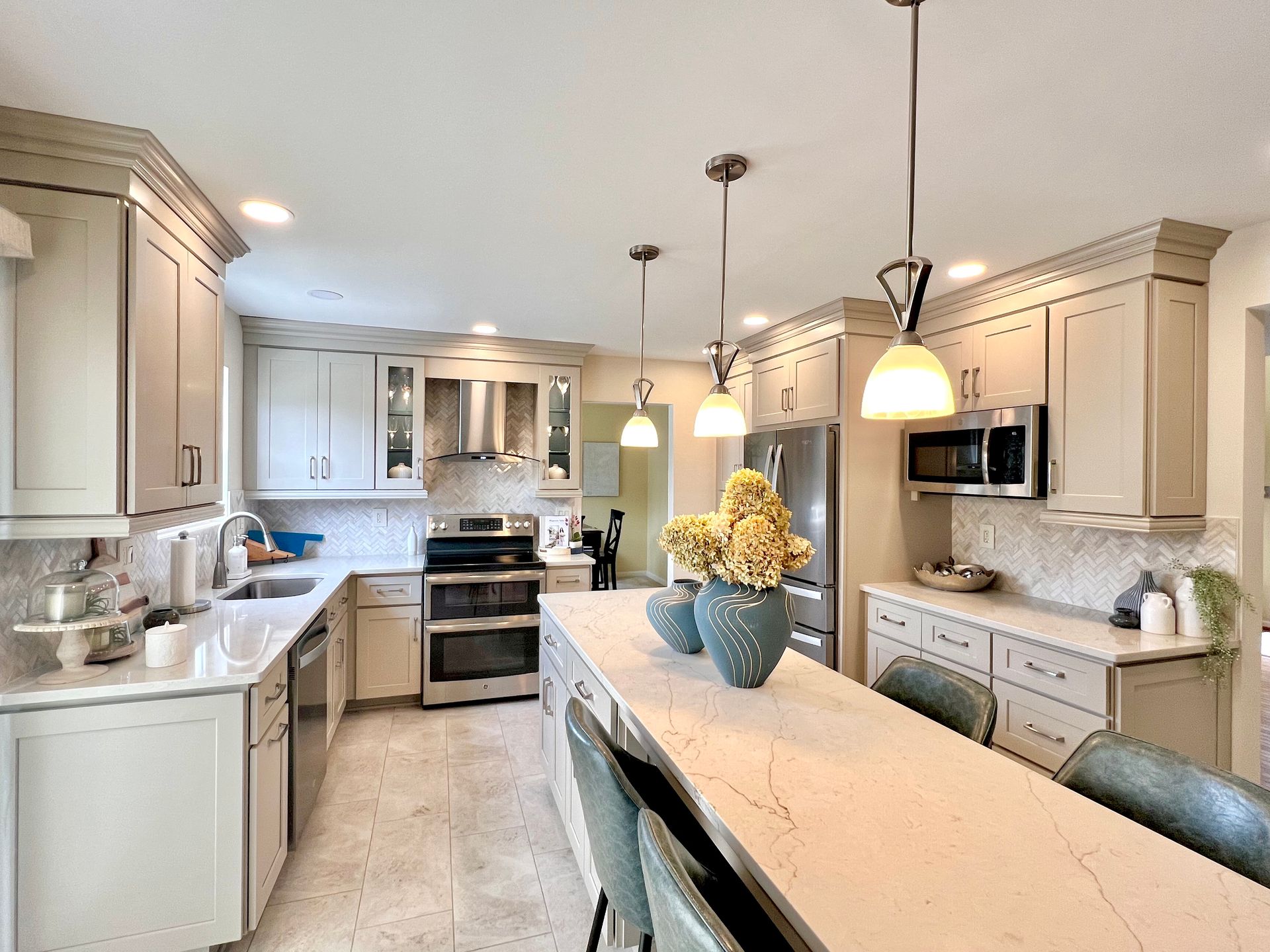 Kitchen renovating project in Sykesville, Maryland, with light gray cabinets extending to the ceiling for maximum storage.