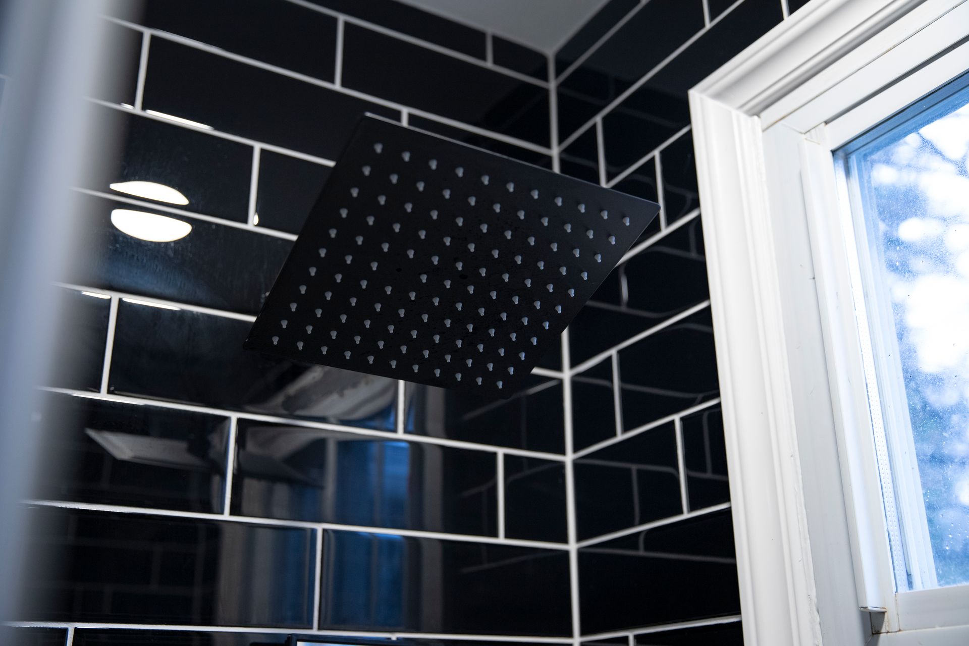 Adding a full-service bathroom to a finished basement for increased home value.