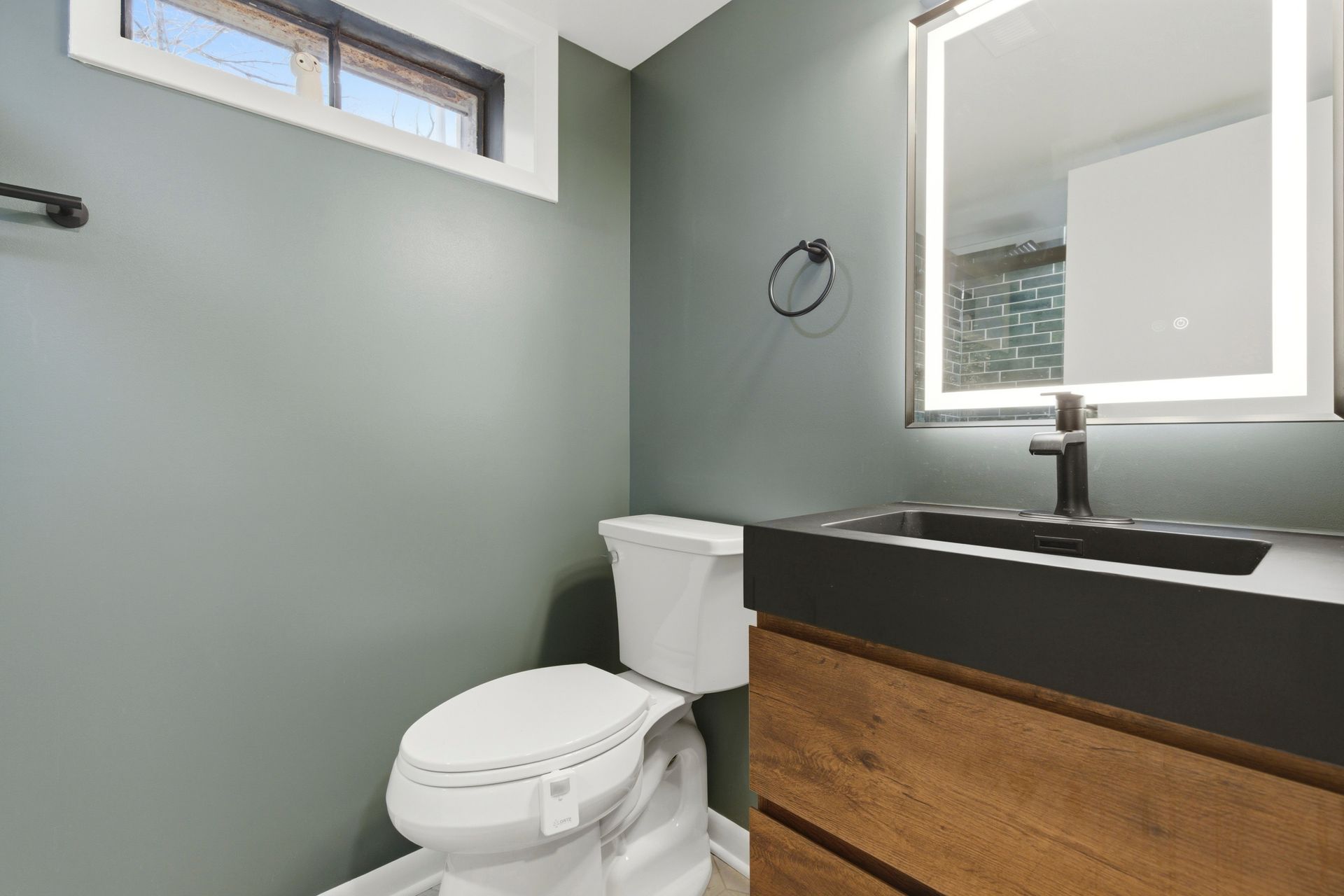 High-end bathroom transformation featuring custom tile and updated fixtures.