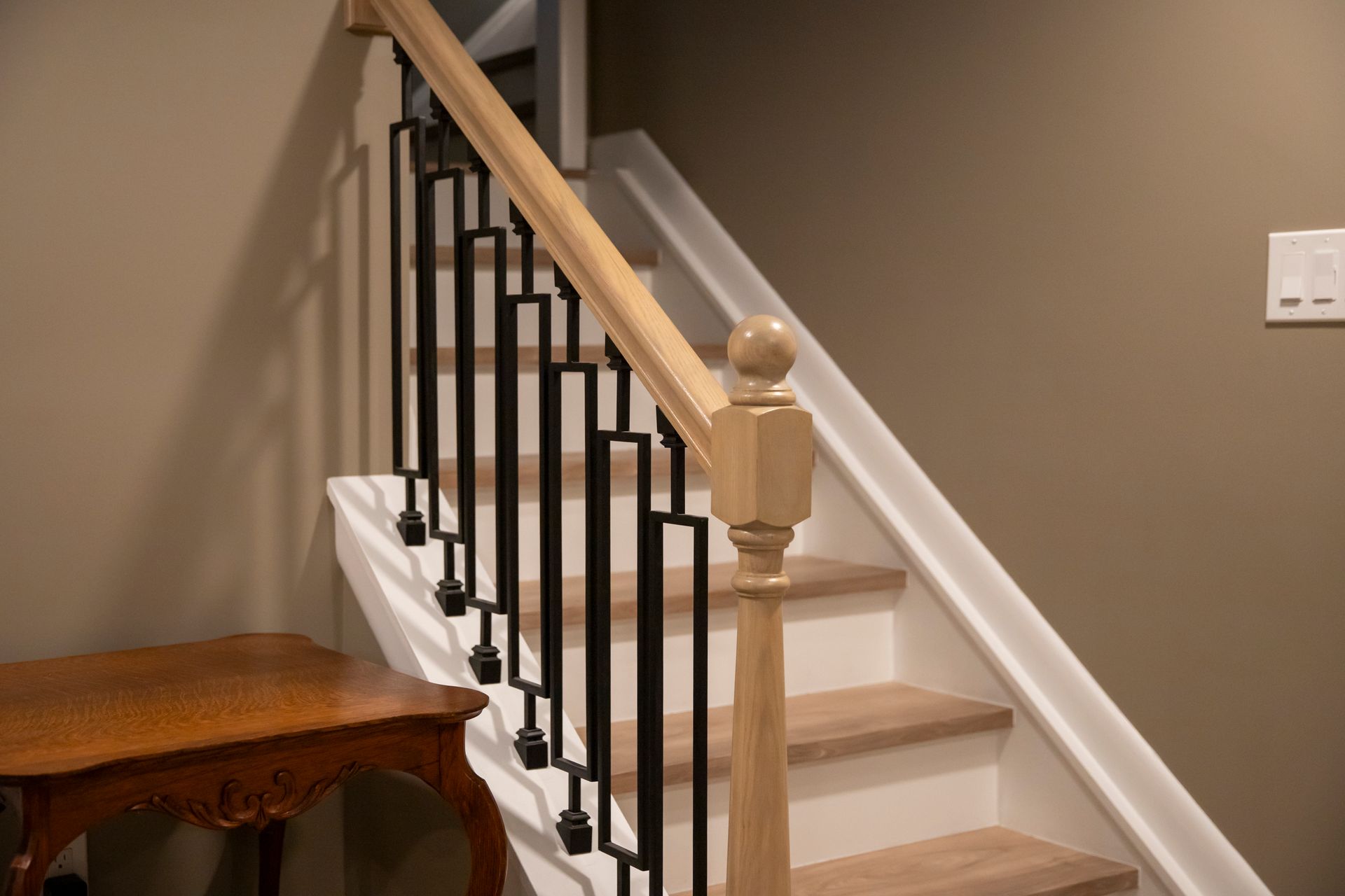 Updated stairs and railings designed to match the new modern flooring of the home.