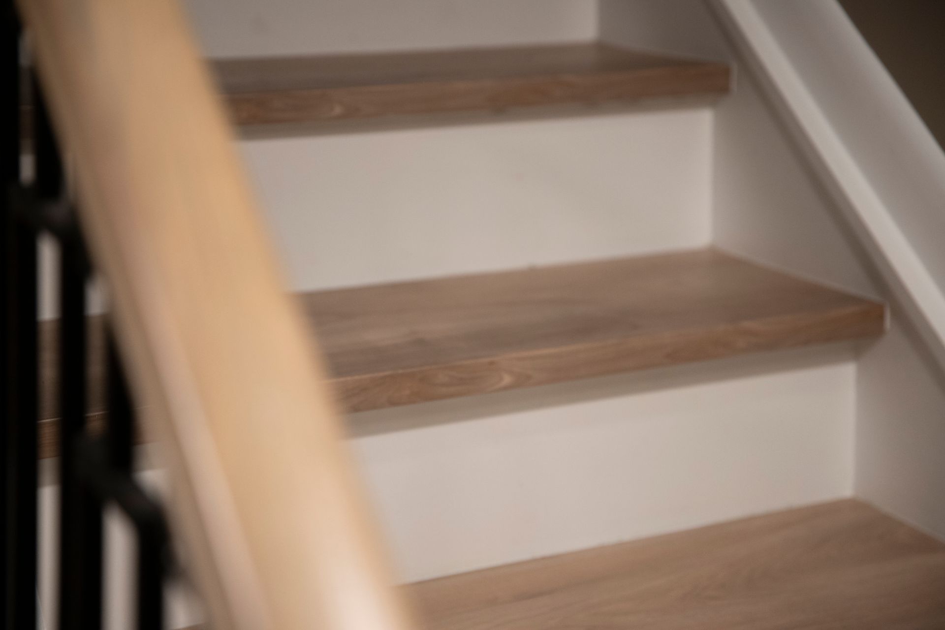 Custom Wood Stair Treads: Newly installed light wood treads for a clean, natural basement entry.