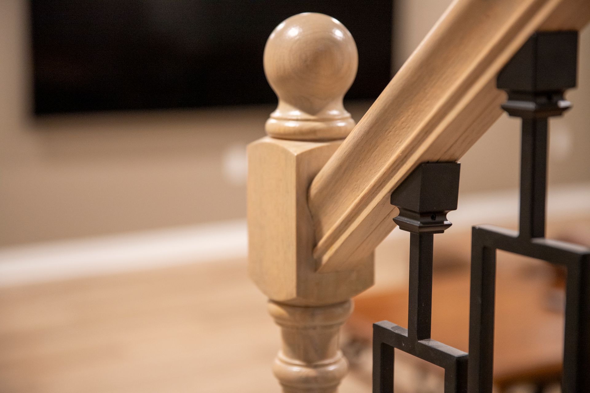 Basement Entry Design: A brightened staircase entry featuring recessed lighting and updated carpentry.
