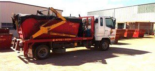 Red Skip Bin in the Truck — Garbutt, QLD – Skippy Skips