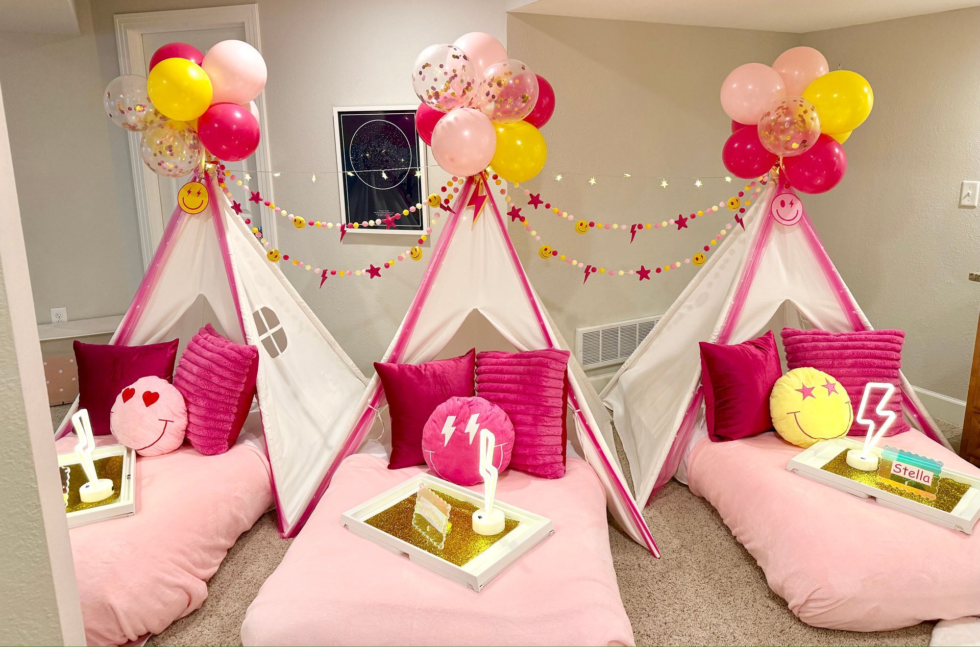 Pink and Yellow Preppy Smiley indoor birthday teepee tent beds with balloons and pillows for party setup