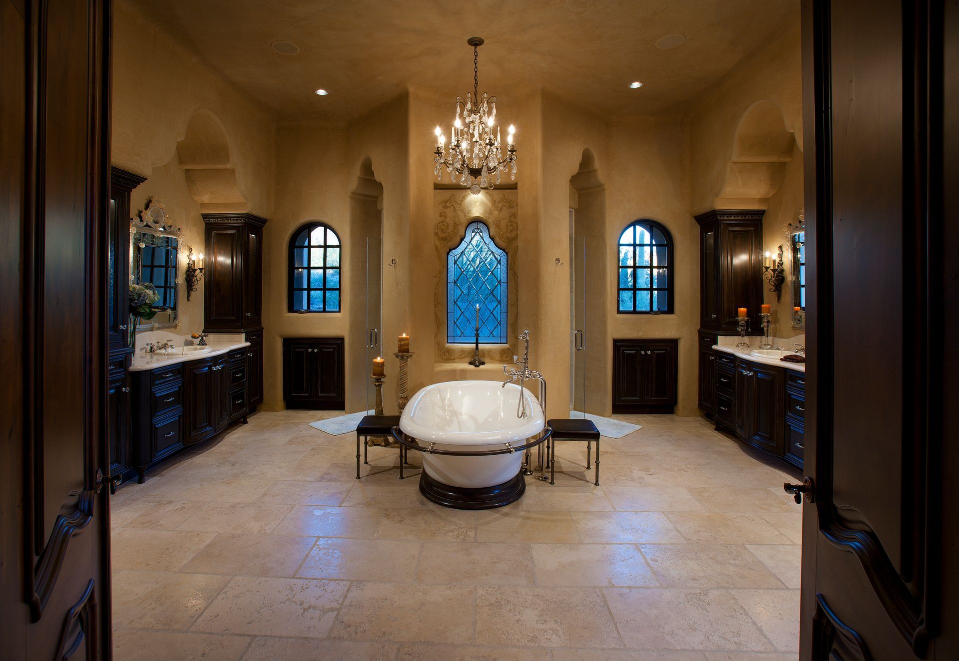 A large bathroom with a bathtub and a chandelier