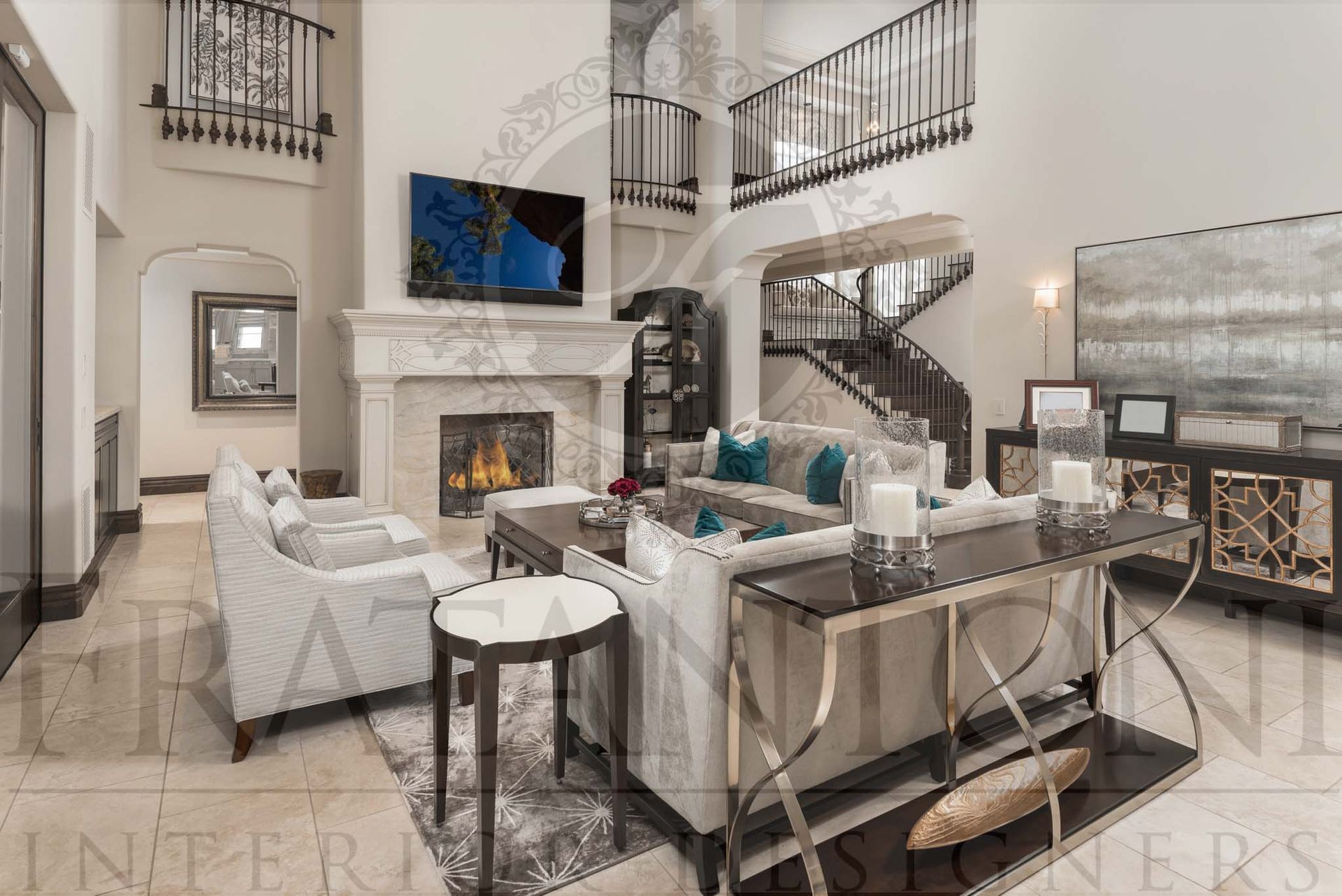 Transitional luxury living room with fireplace, gray sofas, wooden coffee table, grand staircase, and wall-mounted TV with balconies above