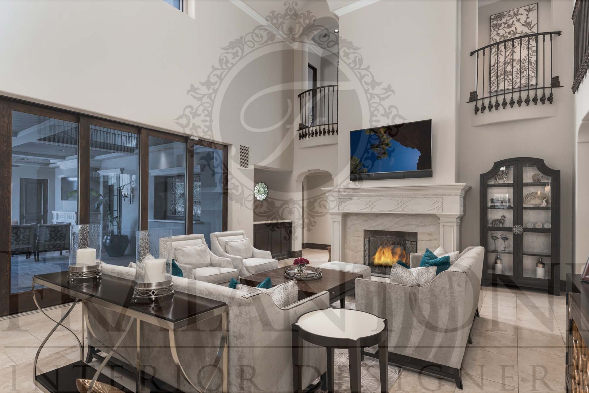 Elegant custom living room with tall ceilings, an ornate carved stone fireplace, large TV, and sliding glass doors to a patio