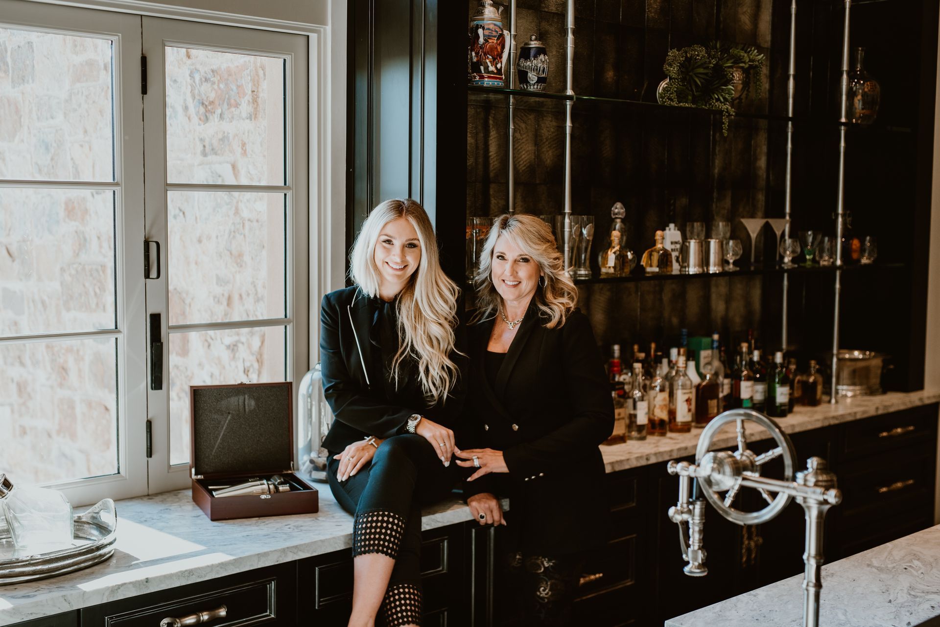 Josie Fratantoni and Jessica Fratantoni posing together in a modern kitchen setting