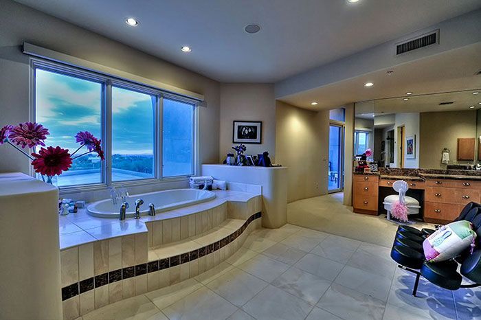 A bathroom with a large tub and a large window