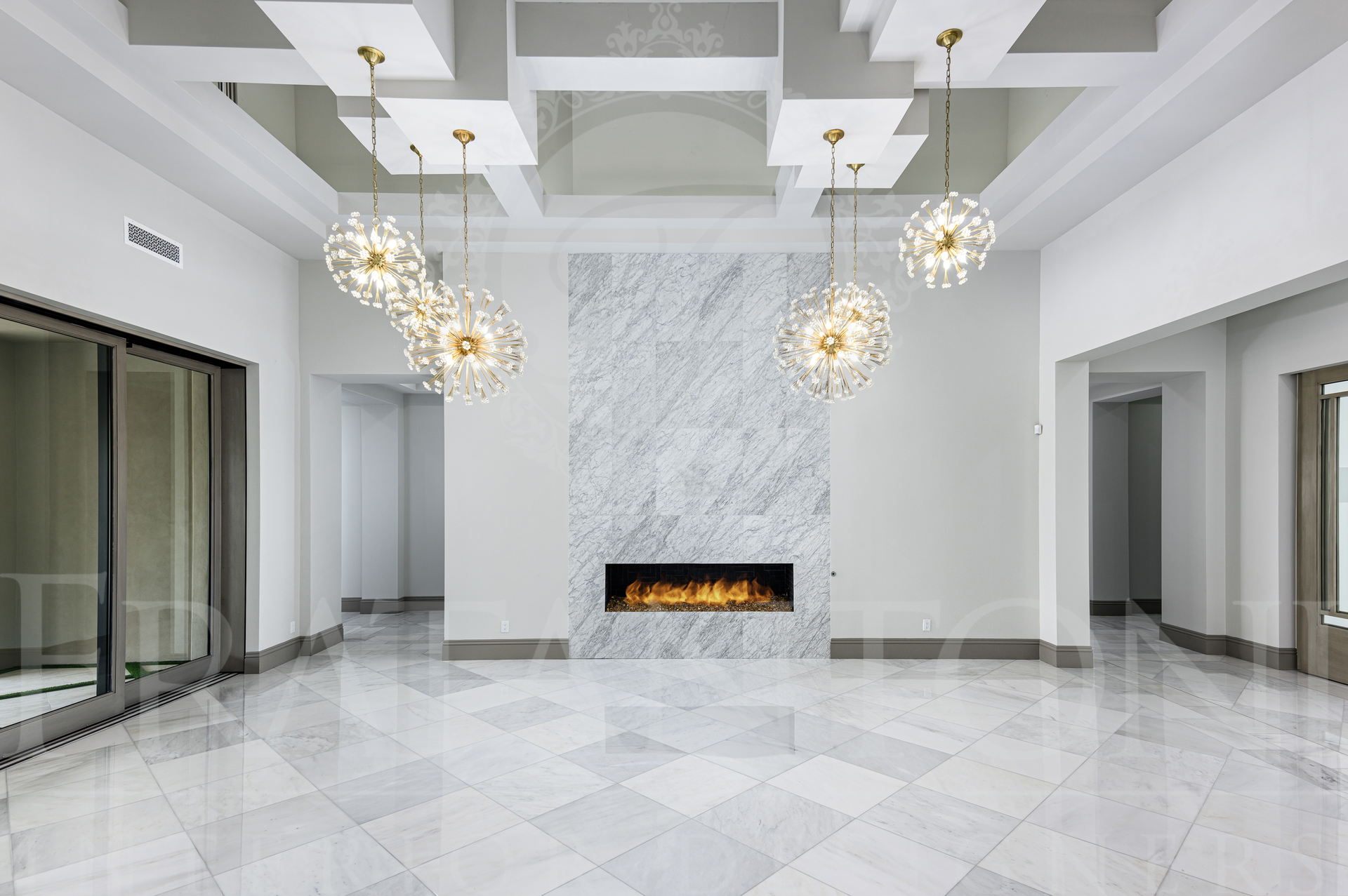 Luxury white living room with marble floor, crystal chandeliers, coffered ceiling, and a central fireplace