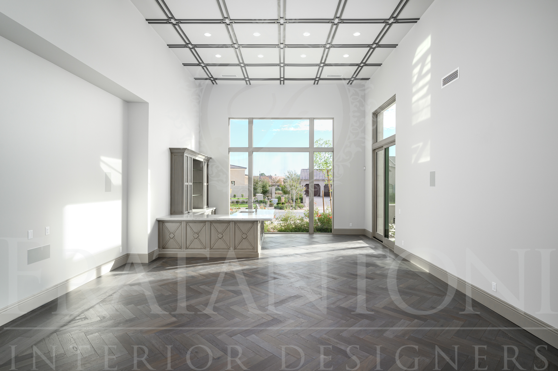 Luxury home office with white walls, large windows with neighborhood views, and a custom built in desk.