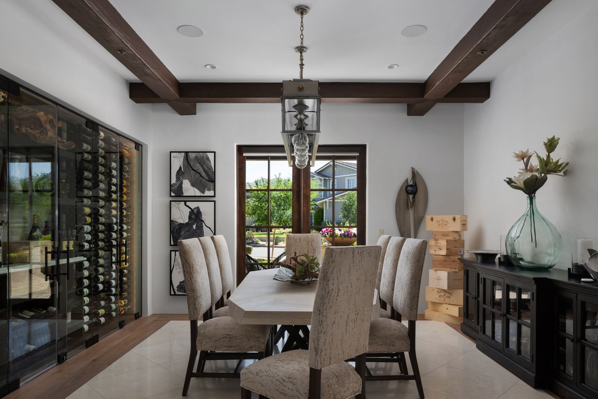 Dining room with wine storage, a table set for dining, and a view to outside through a window.