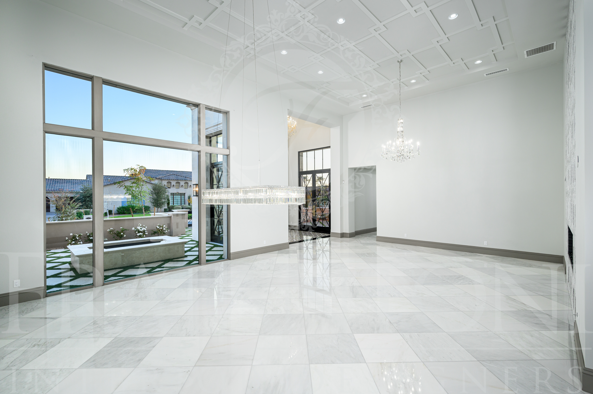 Luxury dining room with marble floors, statement chandeliers, and courtyard views designed by Fratantoni Interior Designers in Scottsdale, Arizona