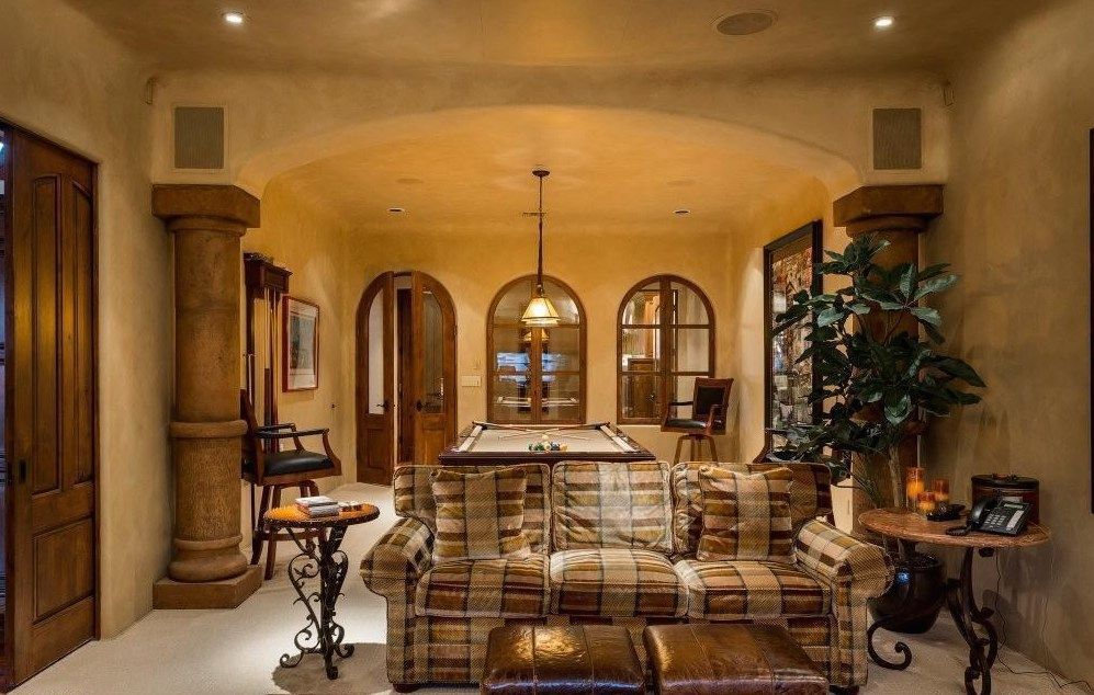 A living room with a pool table and a couch