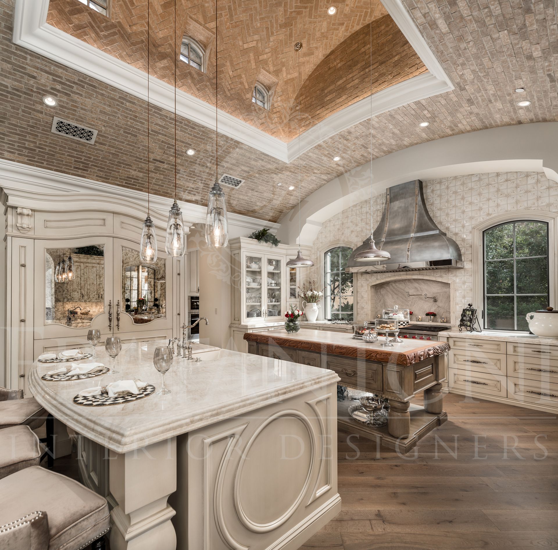 Luxurious kitchen with ornate cabinetry, marble countertops, and brick vaulted ceiling located in silvereaf and designed by fratantoni interior designers.