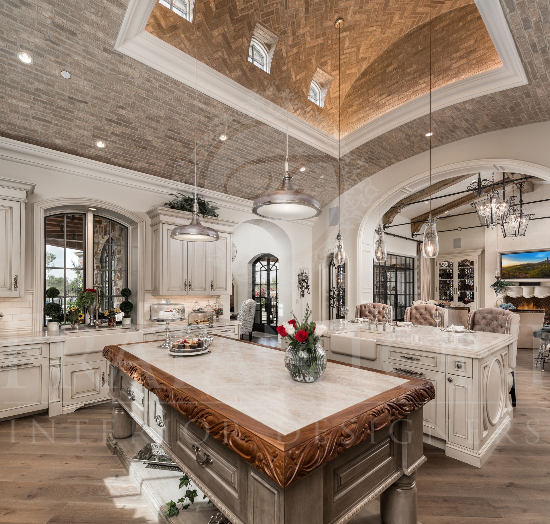 Luxurious kitchen with large double islands, arched brick ceiling, and ornate details.